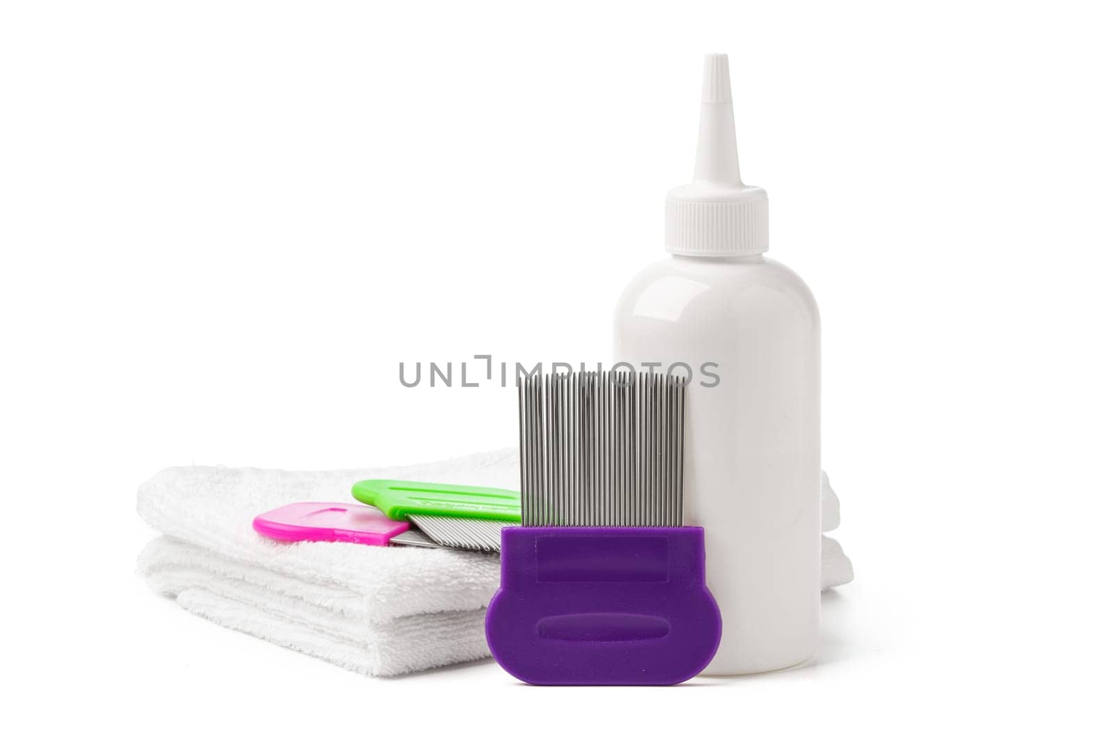 Comb, anti lice medicine and towel on white background close up