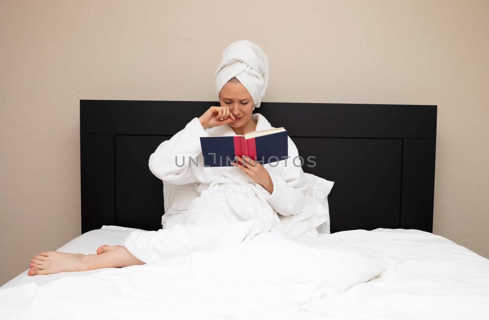 Woman In Her 30s Sits In Bed And Crying Reading A Book. Emotional Empathy Expression Of Face. Sensitive Caucasian Mature Female Reading Romance, Novel Love Sad Story. Book Lover, Horizontal Plane.