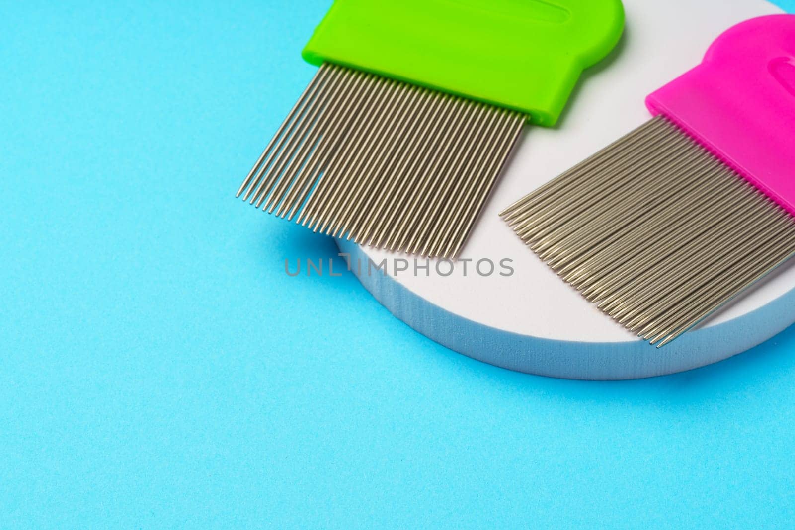 Comb for lice removing on blue background studio shot