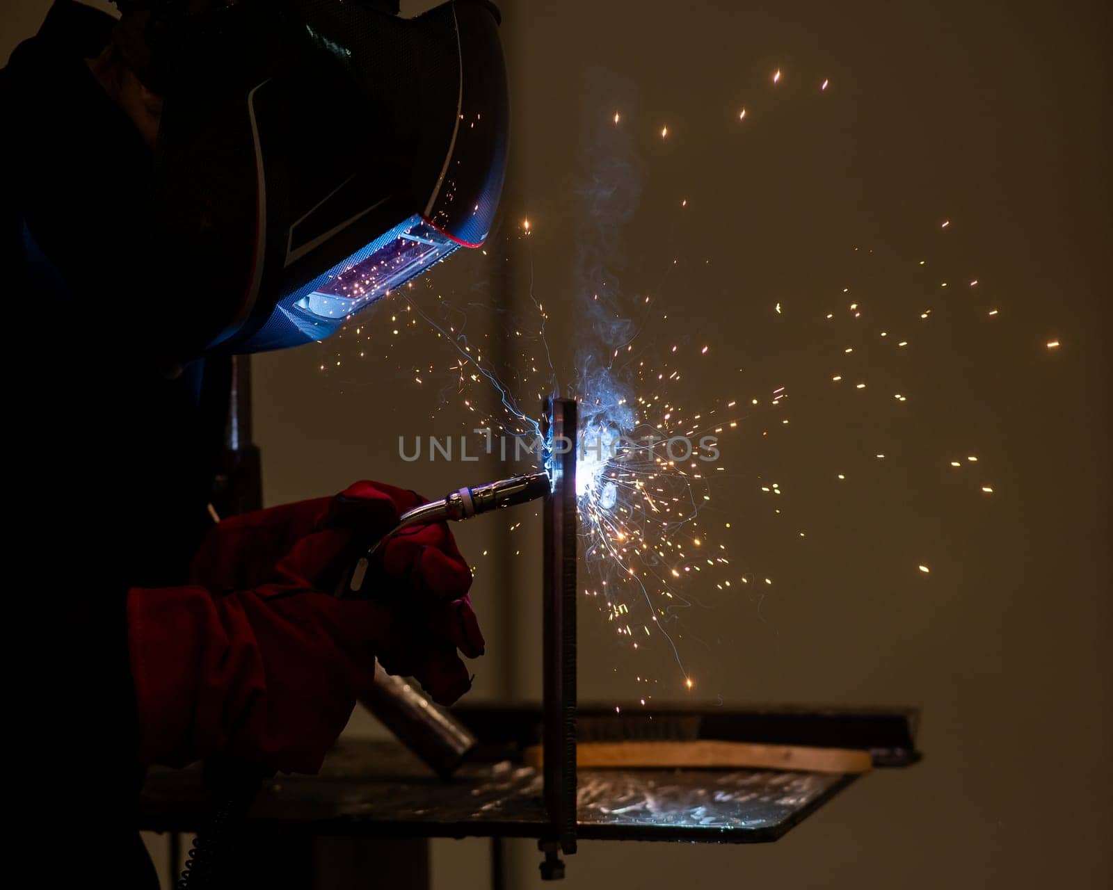 A man learns the craft of welding on a sample. by mrwed54