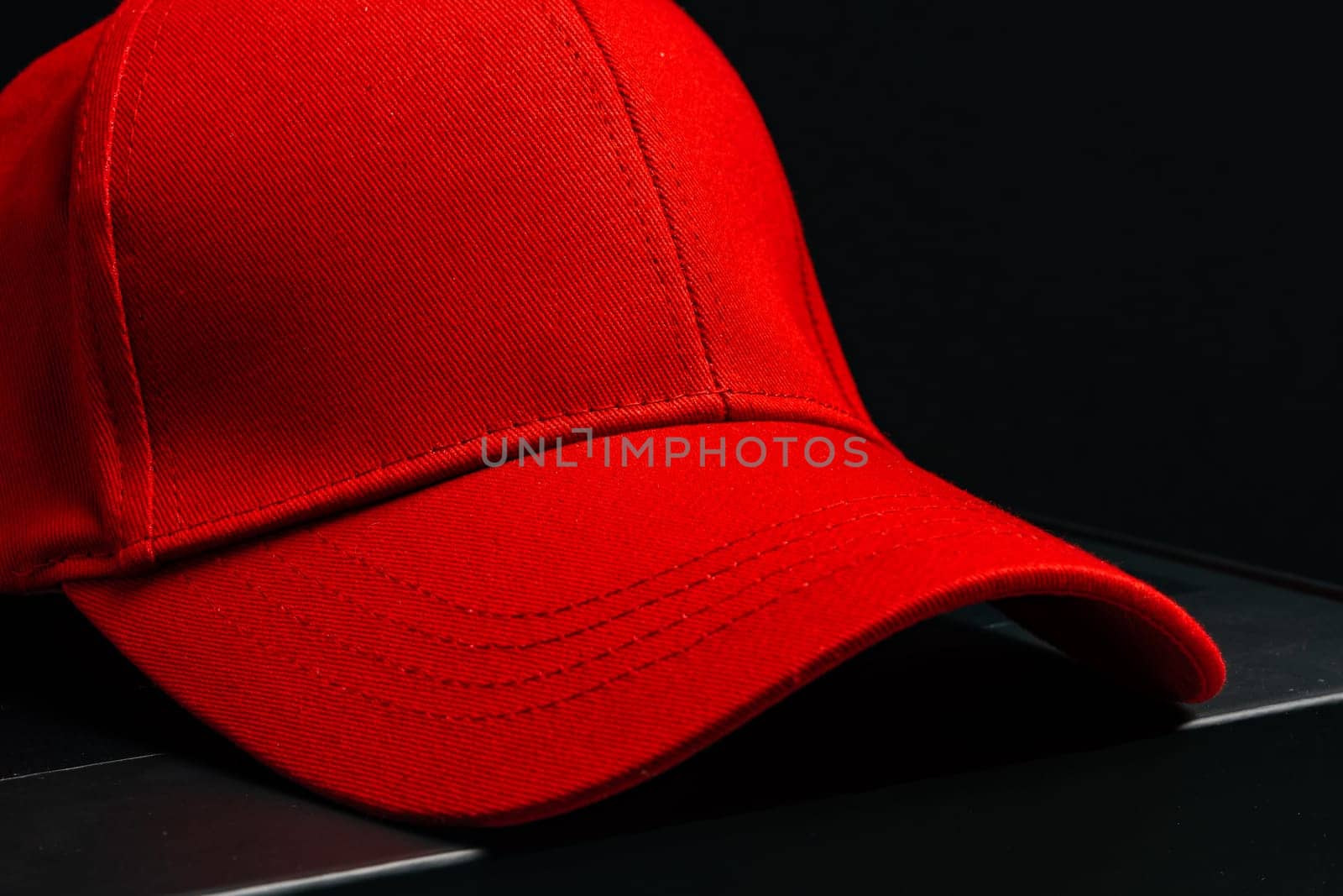 Baseball cap against black background studio shot by Fabrikasimf
