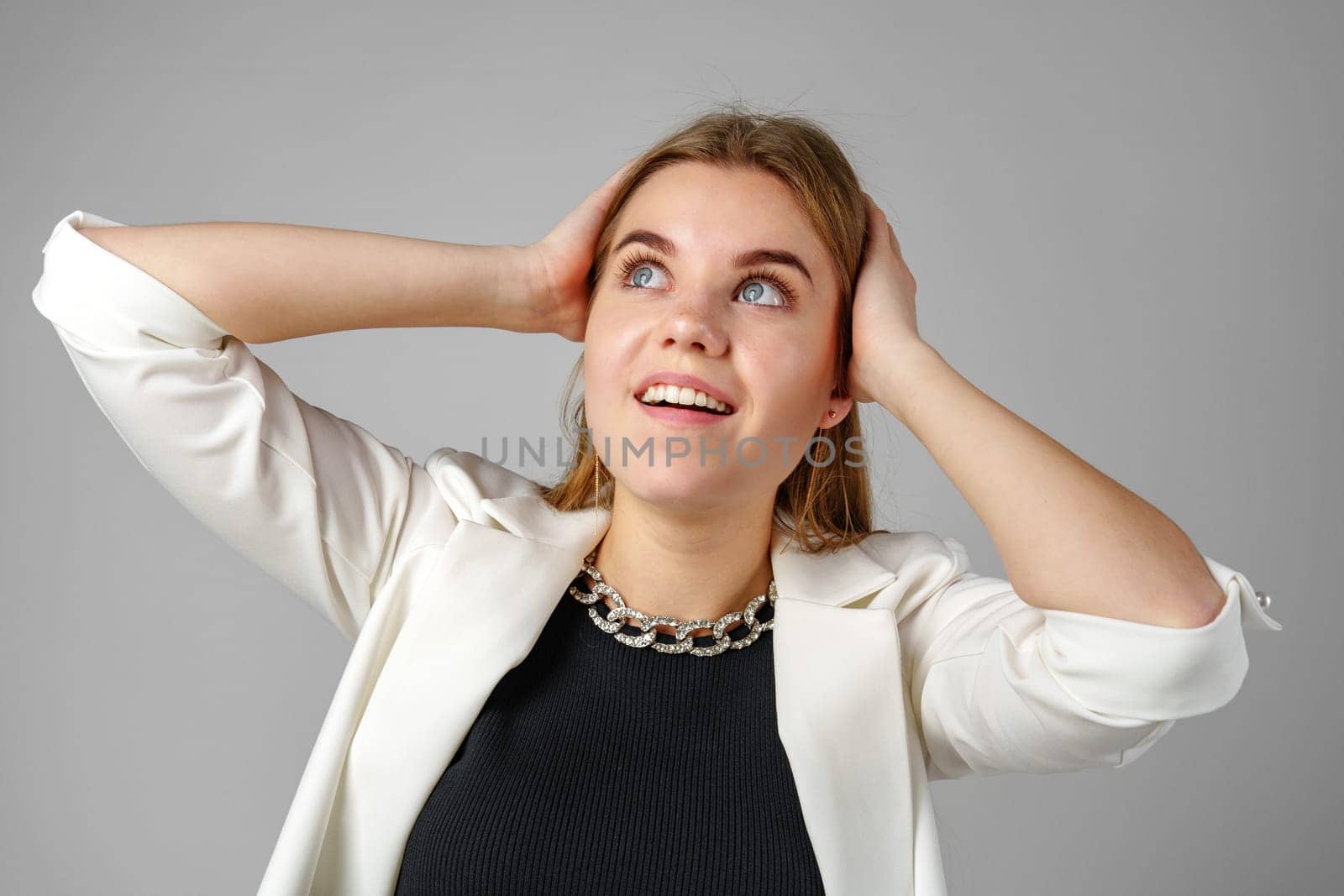 Excited Young Woman in Stylish Outfit Surprised Expression in Studio