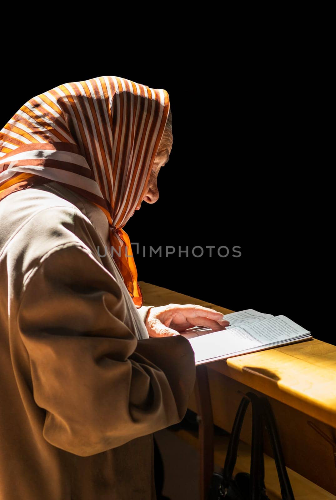 05.05.2024 - Brest, Belarus -Elderly woman reads prayer at Roman catholic church. Religion by pazemin