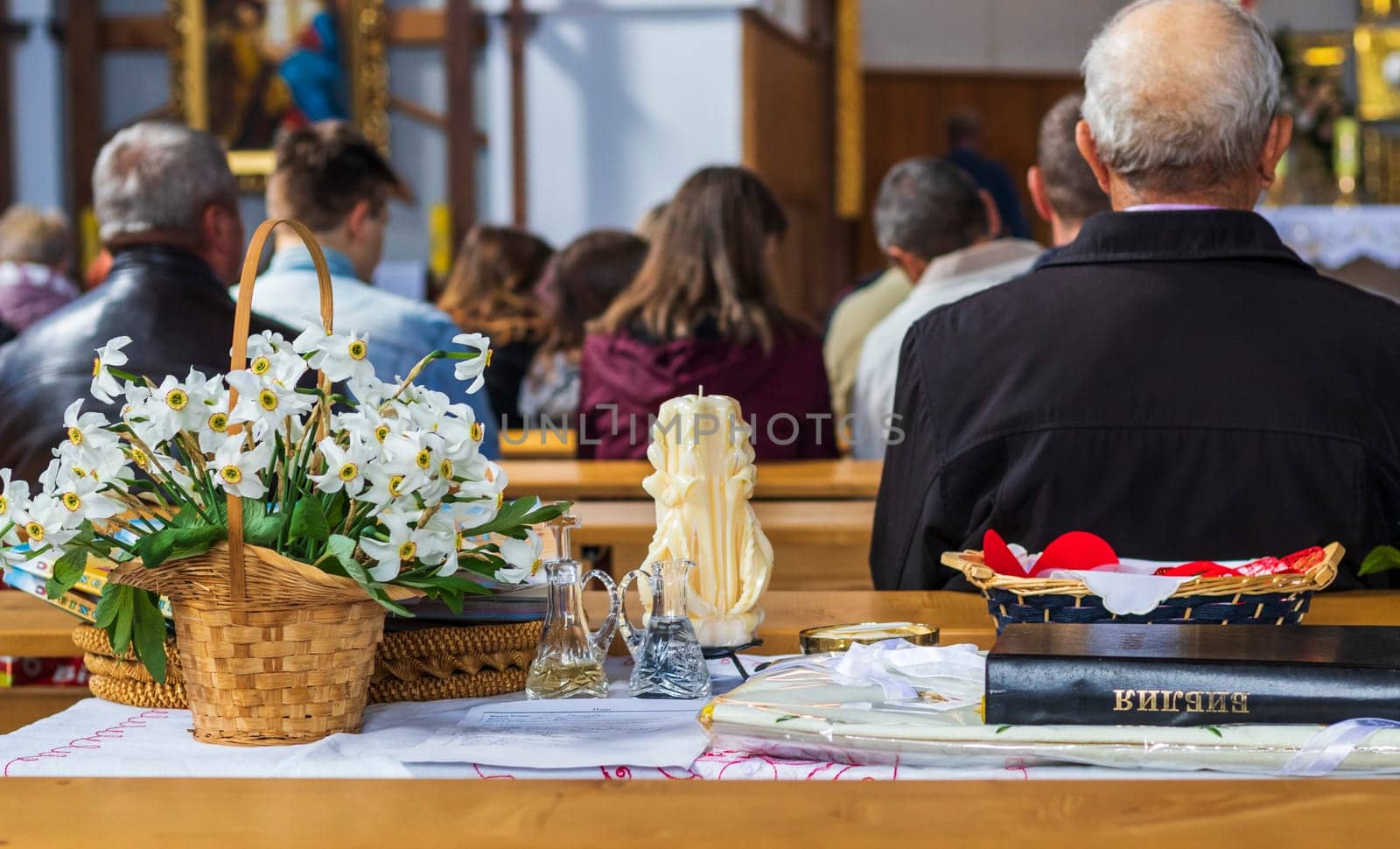 Shot of the people gathered for mass at Roman catholic church. Bible on the foreground