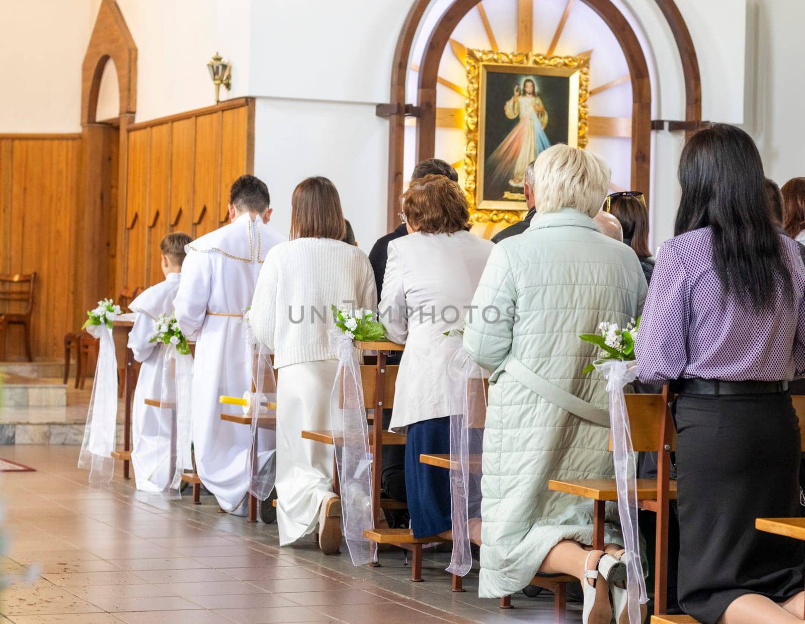 Shot of the people gathered for mass at Roman catholic church.