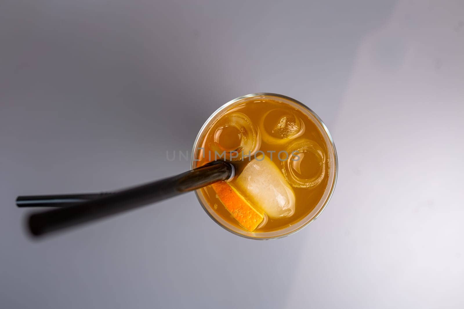 top view orange cocktail with a slice of orange in a glass glass.