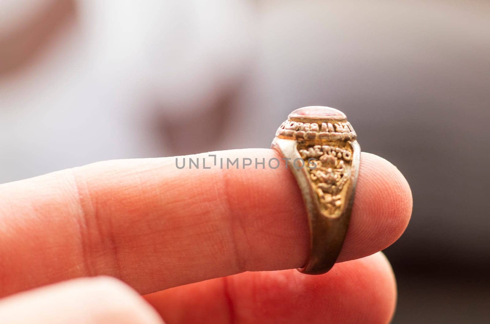 Close up shot of an old, vintage ring with some latin words in it