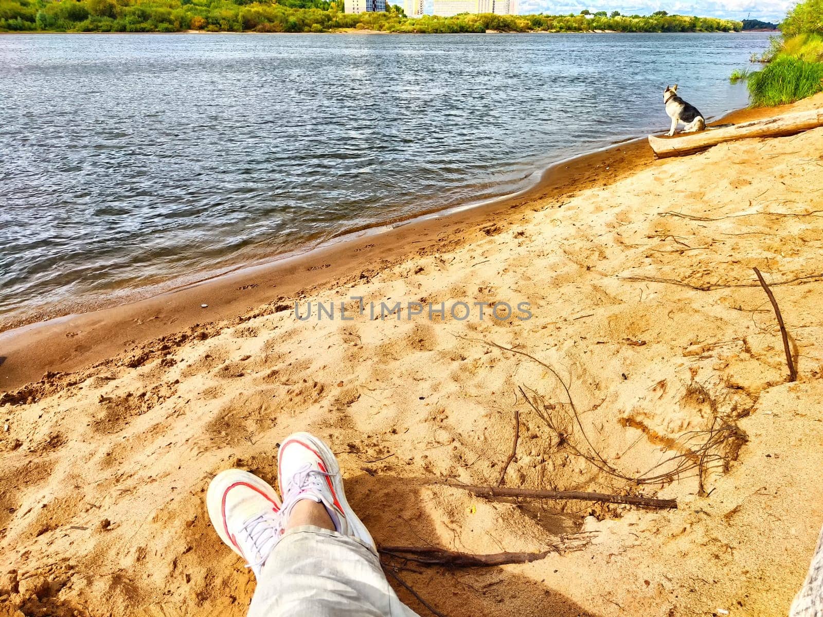 Human feet on a sandy beach. The concept of tourism and recreation. Relaxing Feet on a Sandy Shoreline at Sunset by keleny