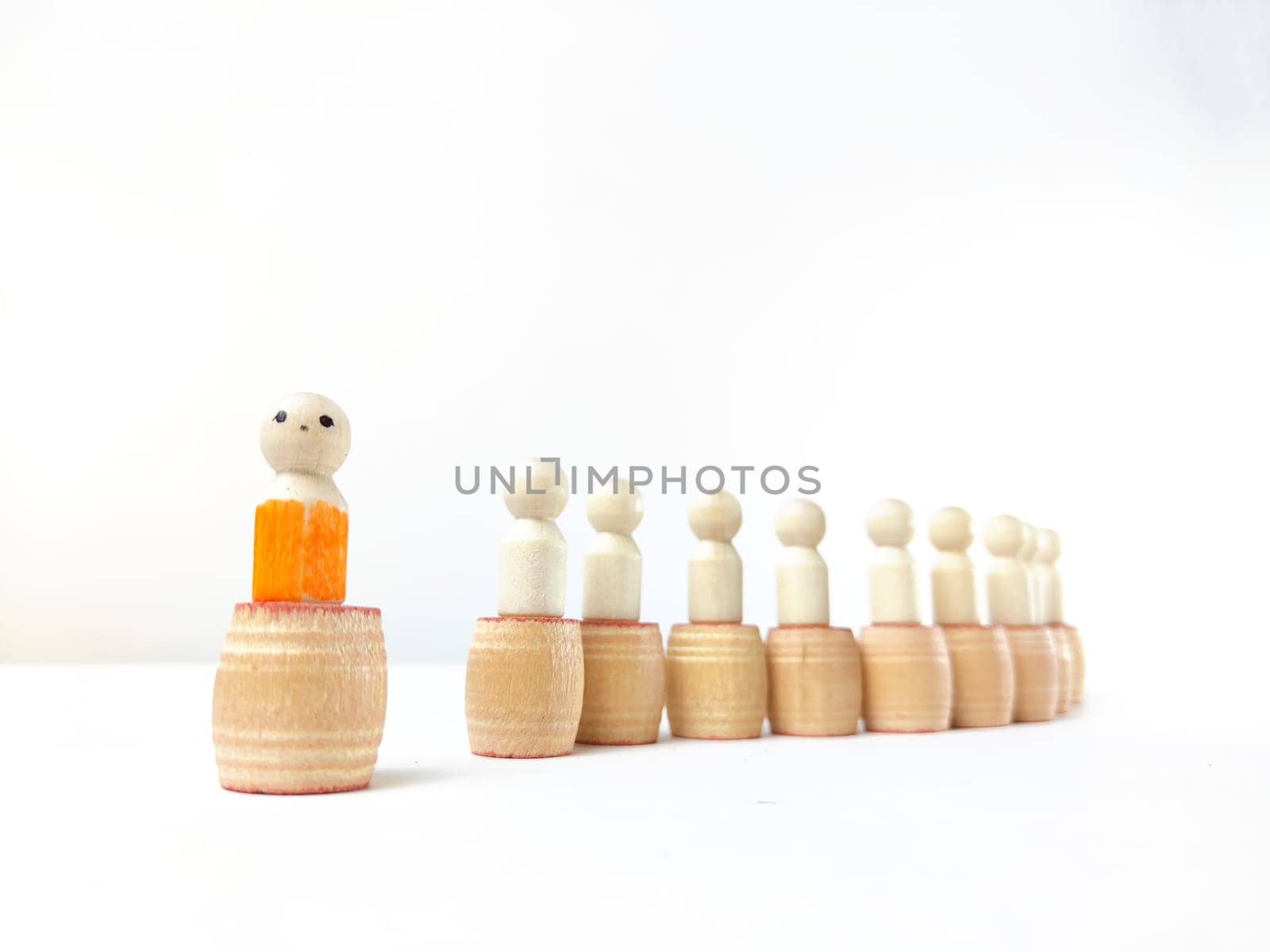 Wooden figurines with a leader and a group. Different, independent, sighted, determined, at head of group. Leadership concept, manager, CEO, market, influencer, opinion leader and business leader by keleny