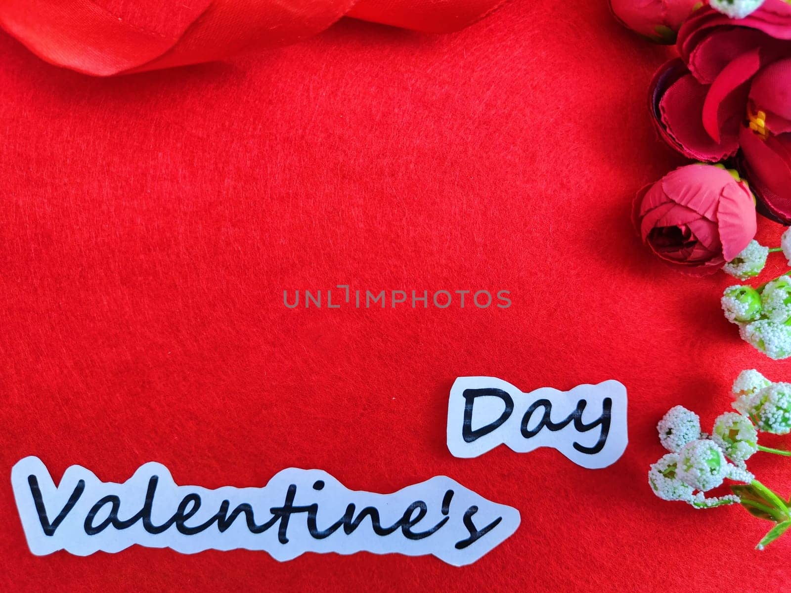 Valentine's Day concept celebration, congratulation. Red greeting Card with flower, Satin ribbon for Background, texture, copy space, place for text by keleny