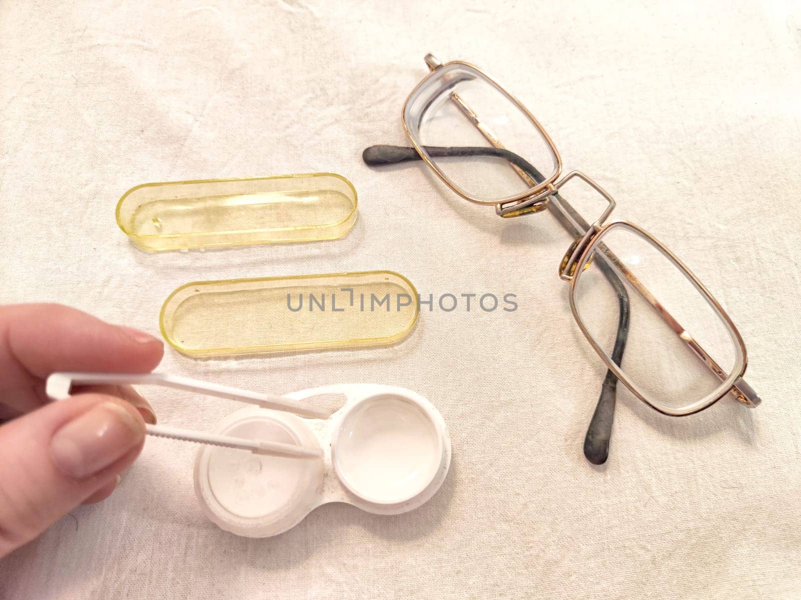Set for contact lenses with a container, forceps, glasses. The concept of correcting myopia. Contact lens care, cleaning, health. Background, copy space
