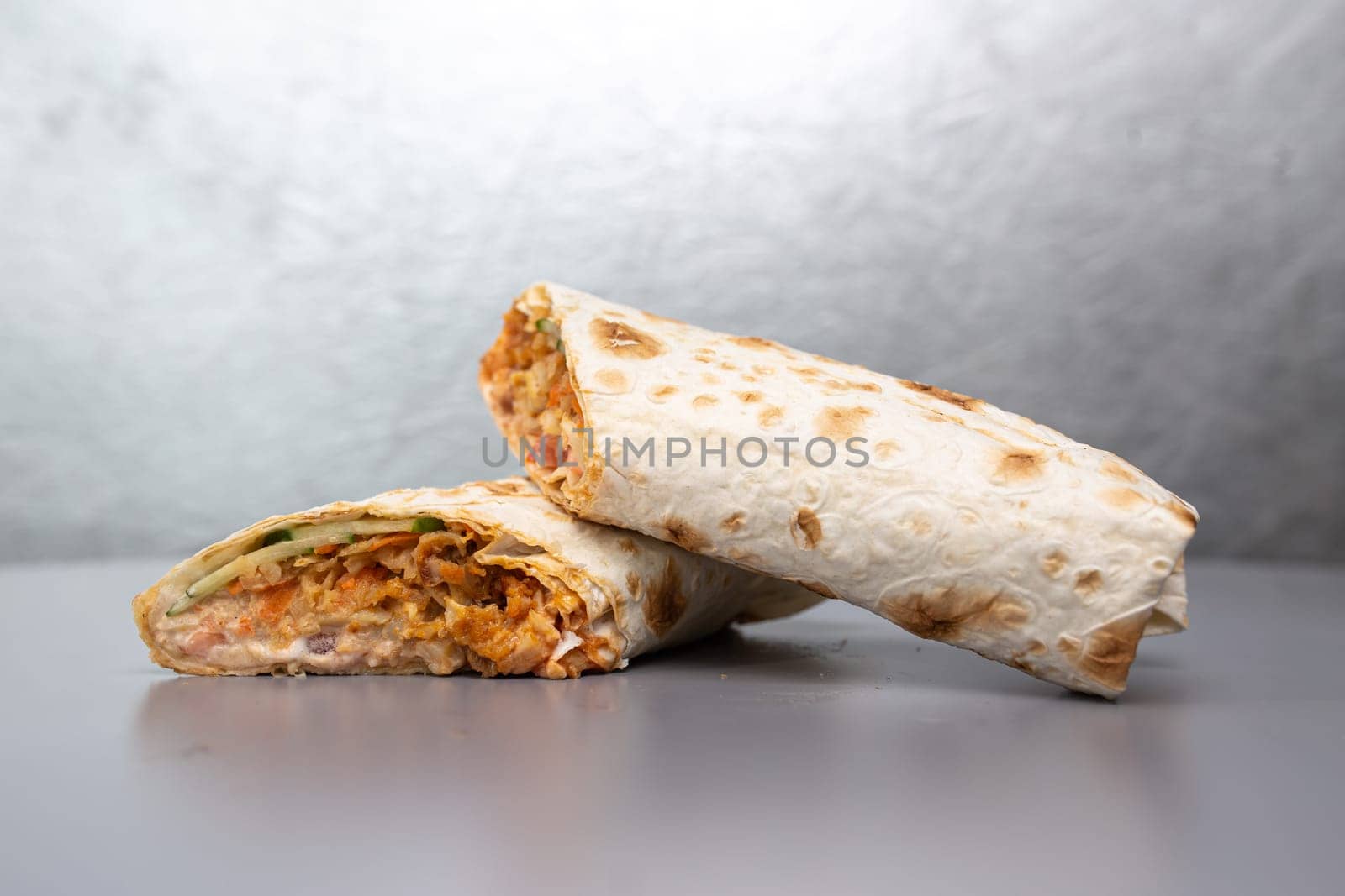 doner with meat filling in a cut on a gray background.