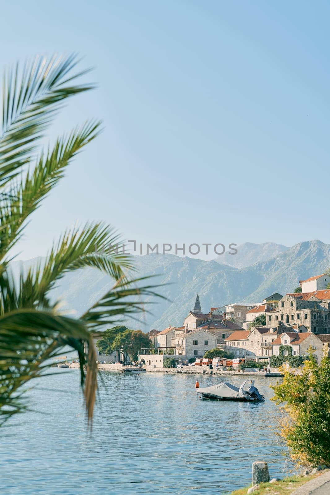 Motor boat in a cover stands on the pier in Perast. Montenegro by Nadtochiy