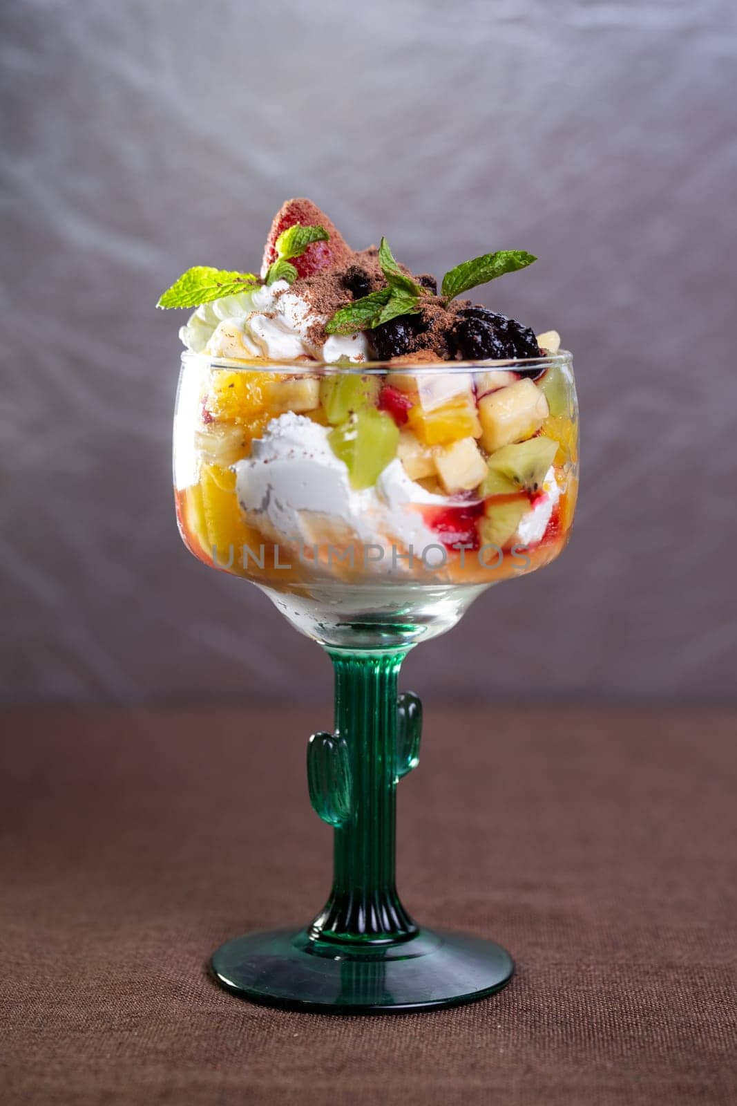 dessert with ice cream and fruit in a glass.