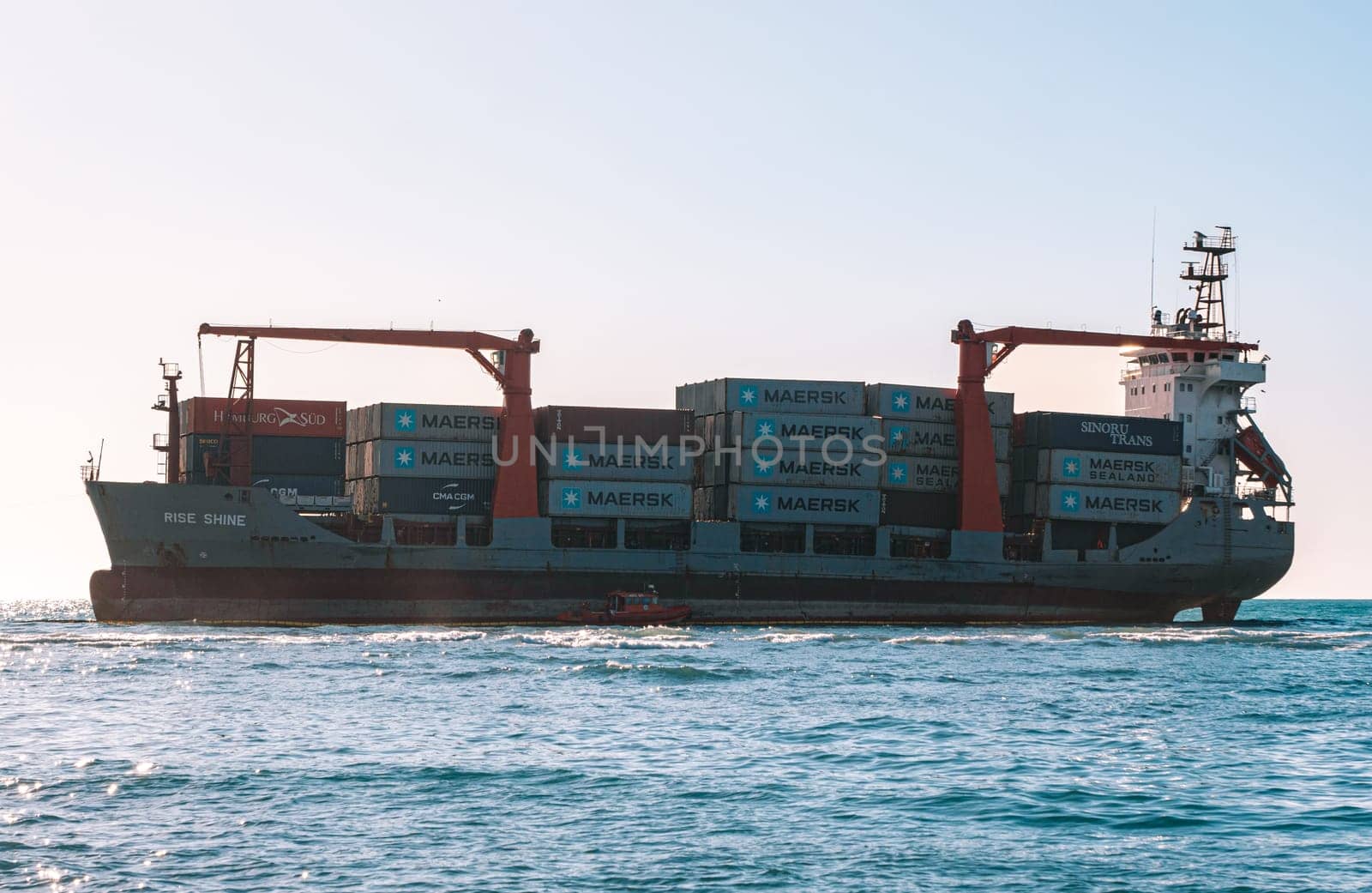 Container cargo ship stands aground after a storm.