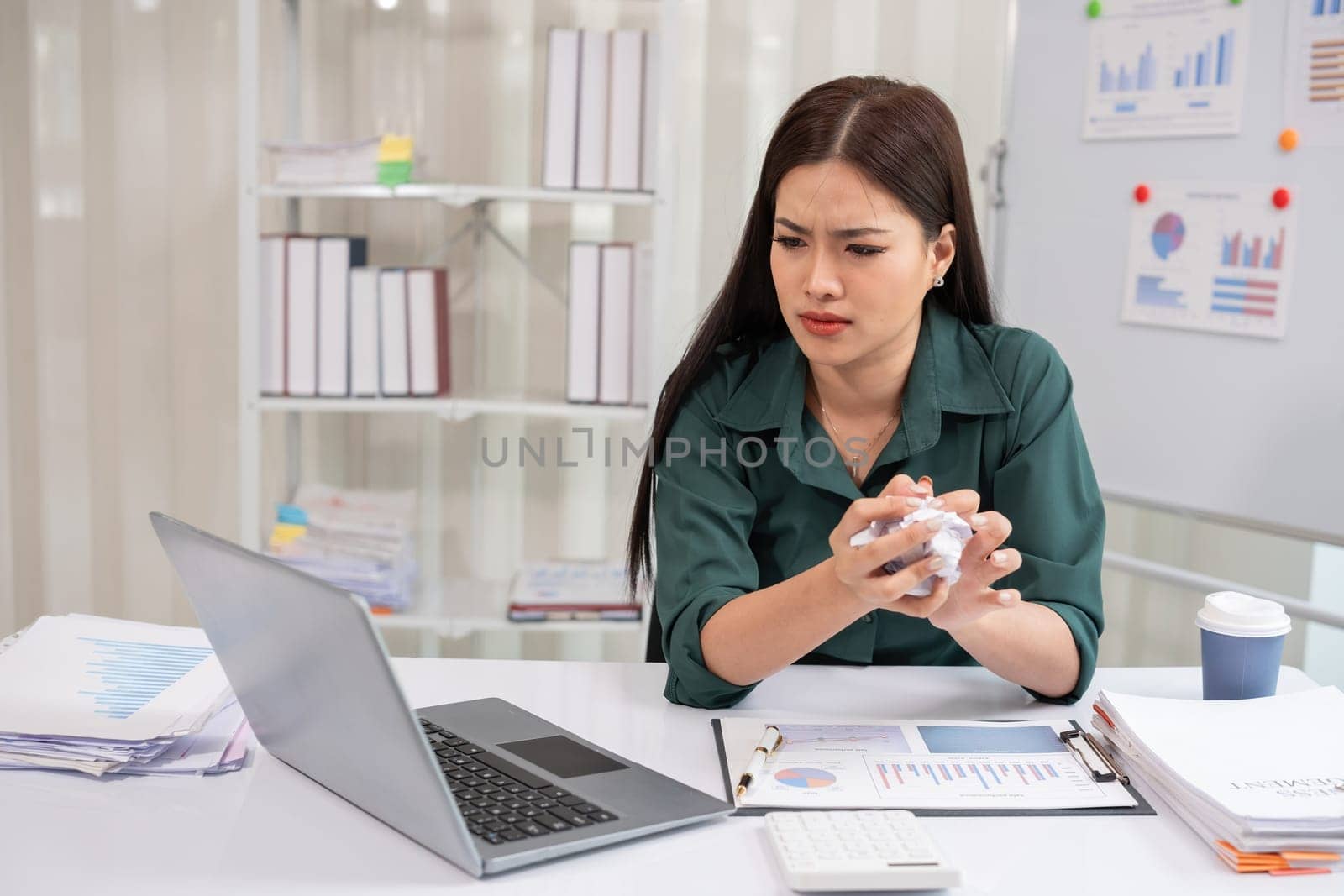 Young businesswoman has problems with her work in the office Feeling stressed and unhappy, showing a serious expression.