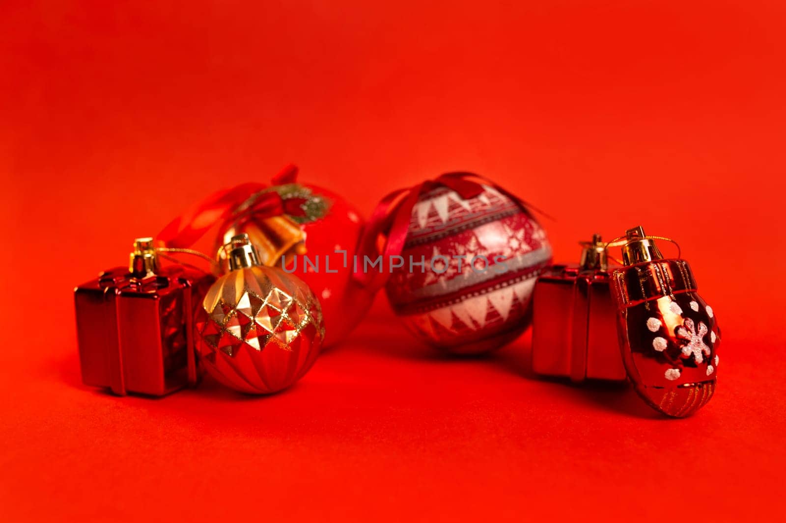 new Year's golden toys on a red background by Pukhovskiy