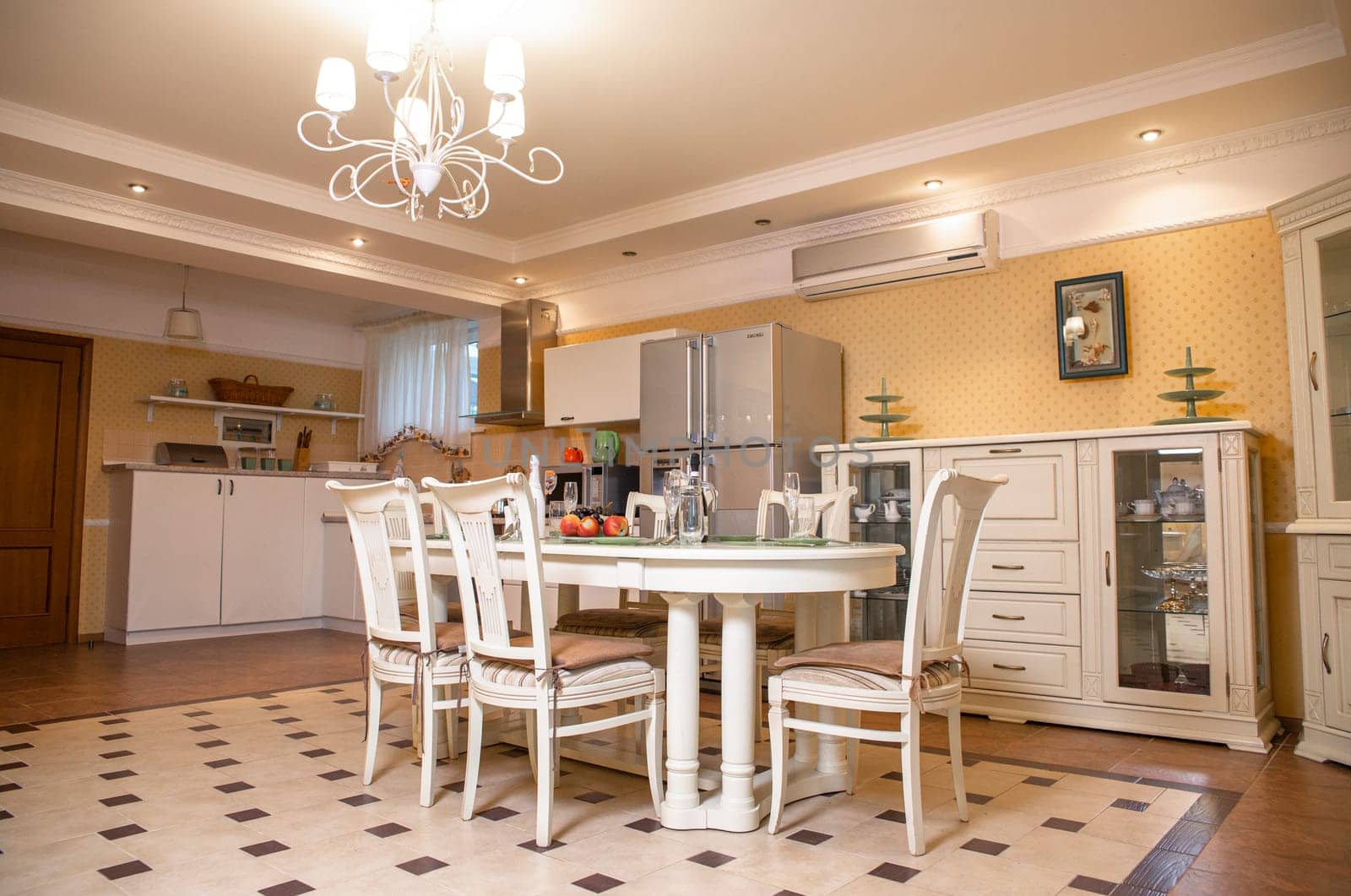 bright kitchen with a dining area. stylish table and chairs in the room.