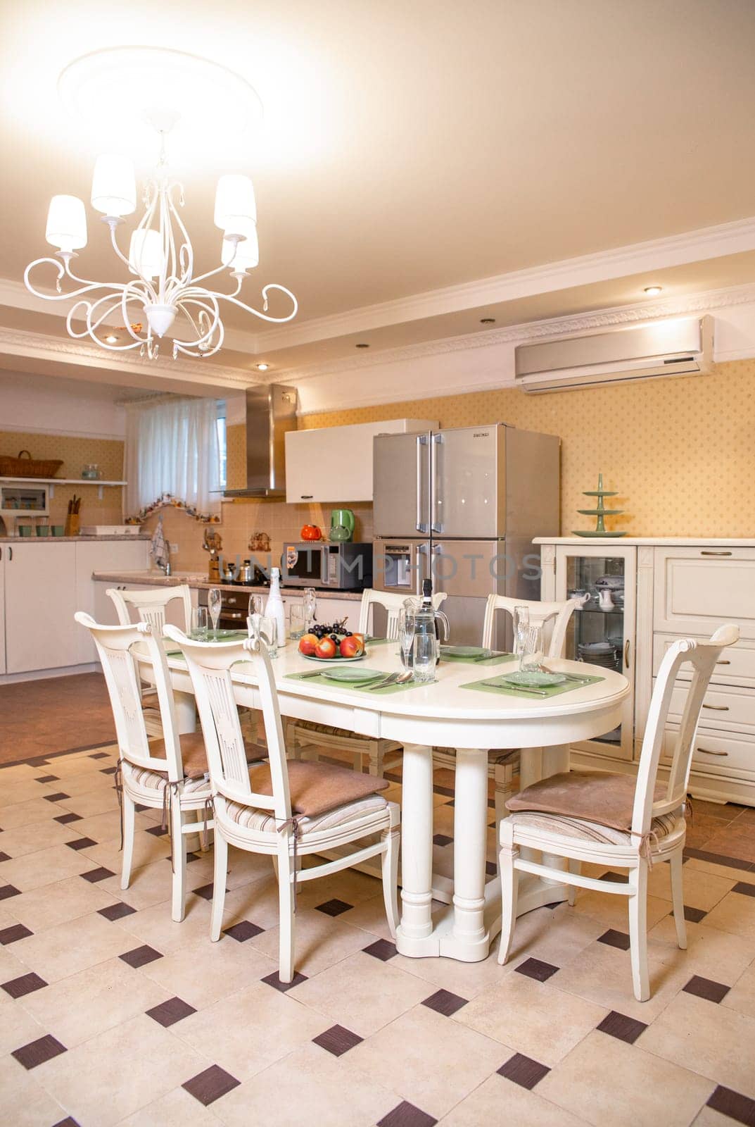 bright kitchen with a dining area. stylish table and chairs in the room.