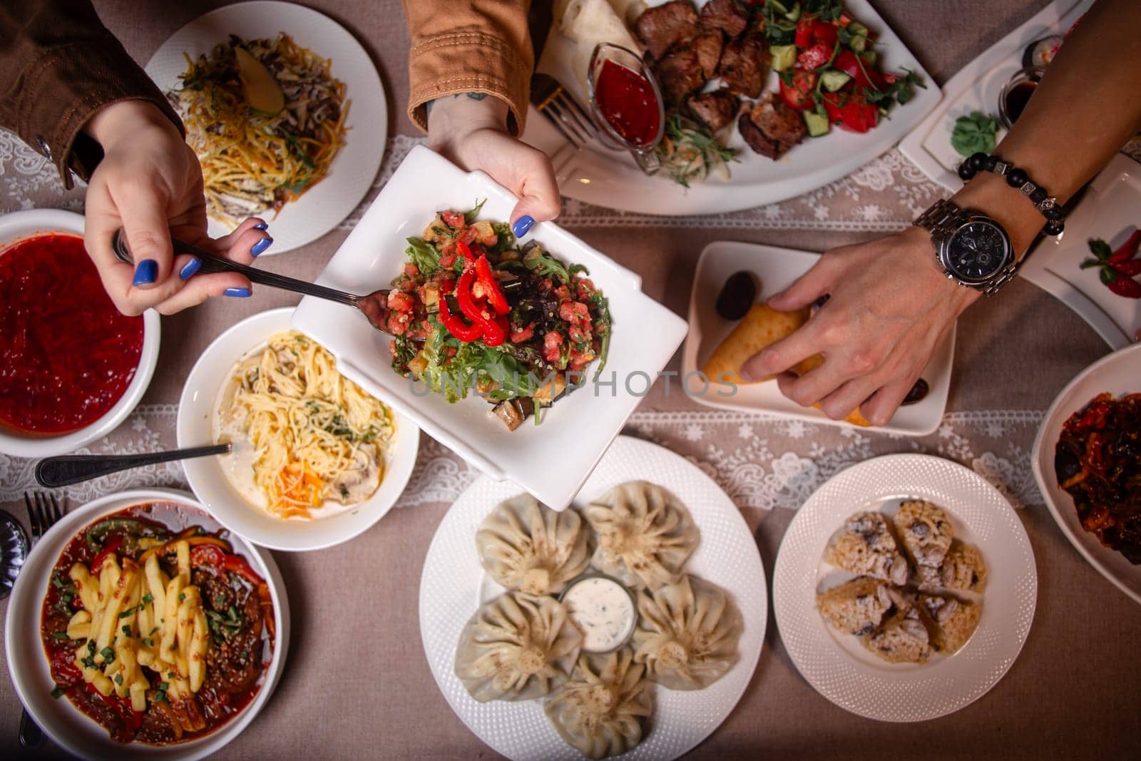 A table with delicious Uzbek dishes like soup, salad, dumplings, and meat skewers, offering a taste of Uzbekistans culinary heritage