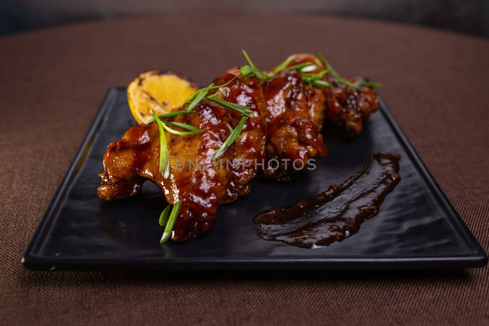 Delicious And Spicy Grilled Chicken Wings With Lemon Garnish by Pukhovskiy