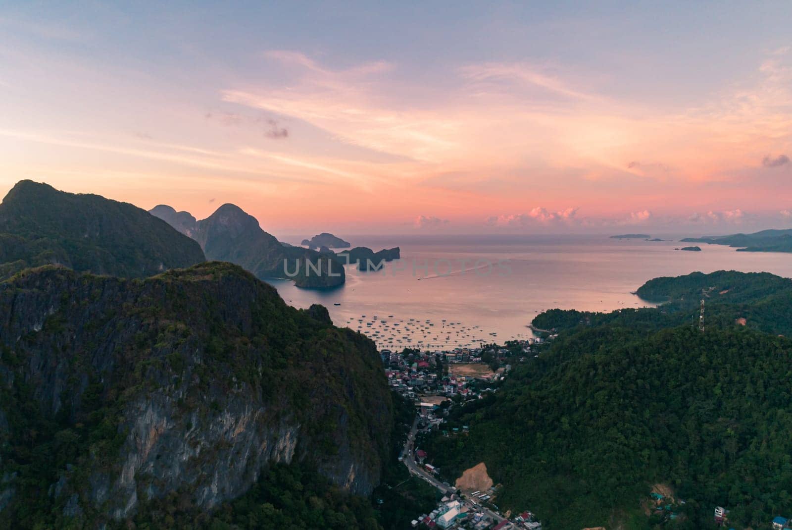 Aerial view over mountain with tropical lagoon on the background at sunset. El Nido, Palawan.