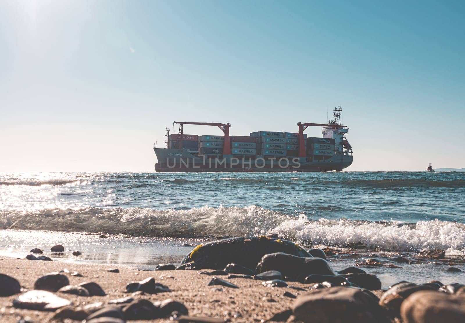 Container cargo ship stands aground after a storm.