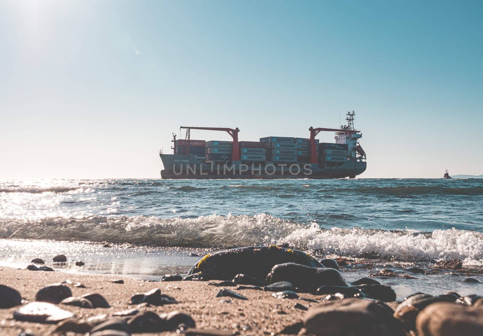 Nakhodka, Russia - November 13, 2021: RISE SHINE container cargo ship stands aground after a storm. by Busker