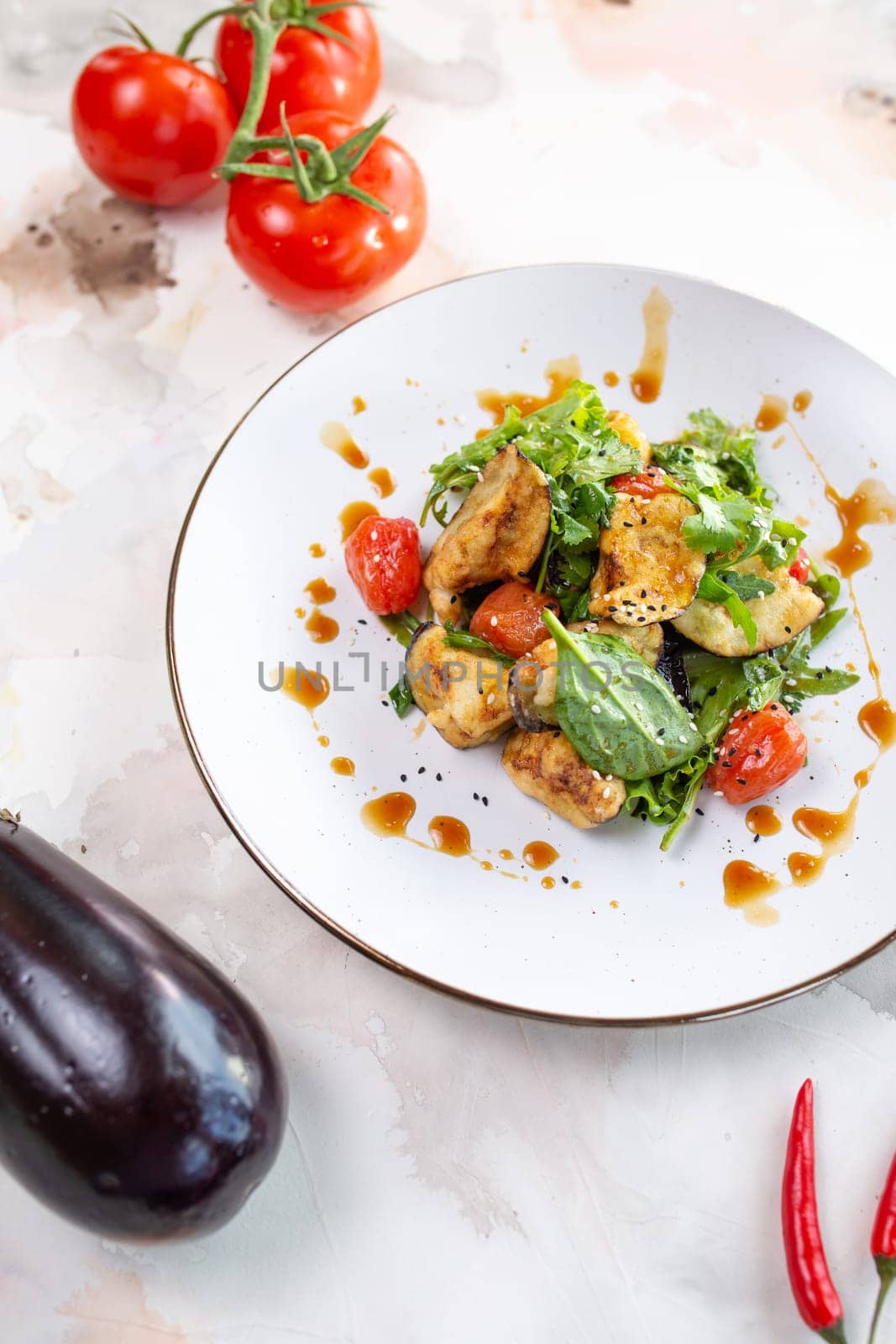 A delicious and healthy salad with grilled vegetables, greens, and tomatoes. Perfect for a light lunch or side dish.