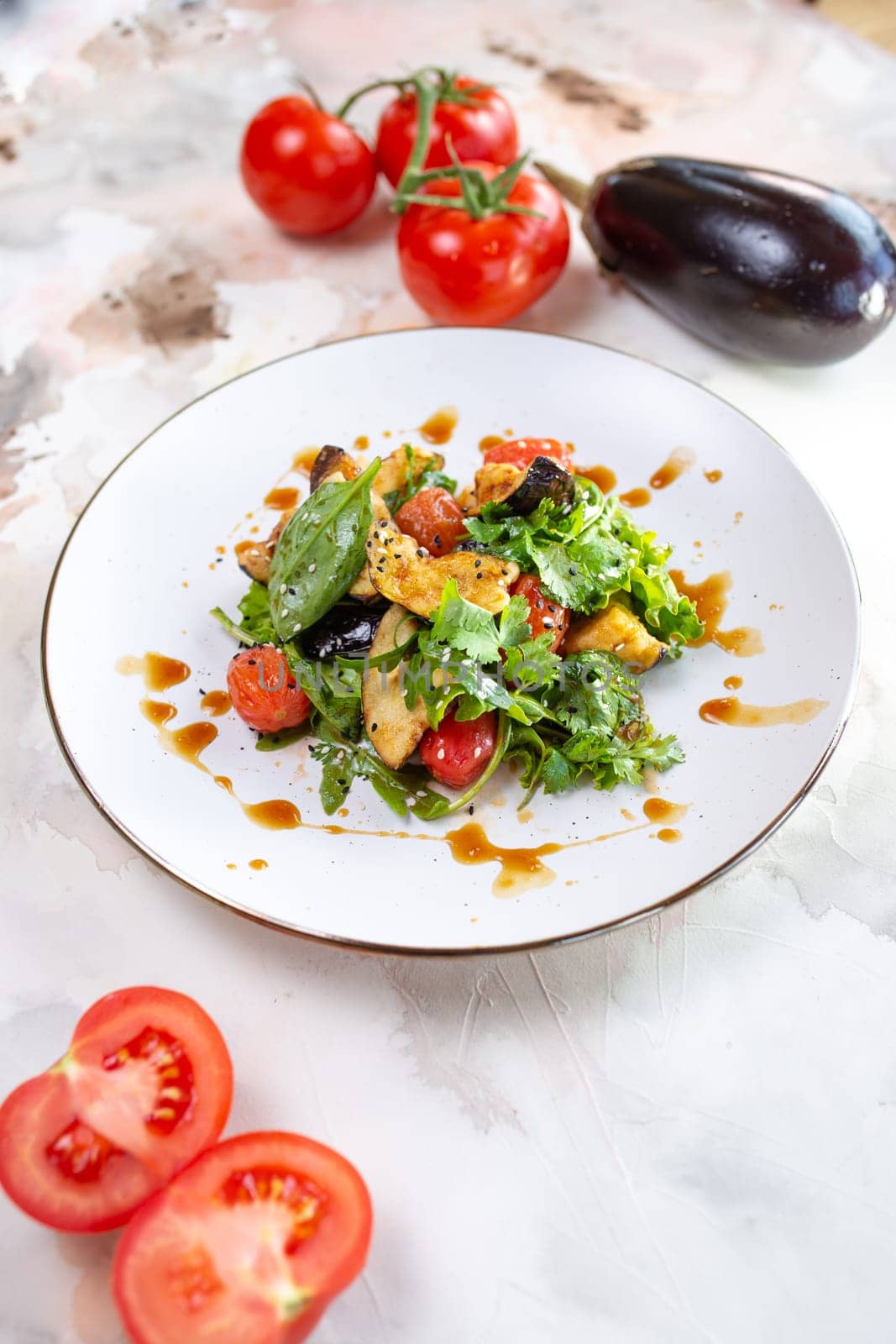 A delicious and healthy salad with grilled vegetables, greens, and tomatoes. Perfect for a light lunch or side dish.