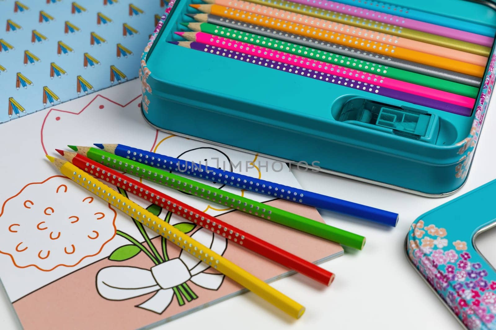 Colored pencils for drawing various colors and coloring book for children. Children's creativity concept.