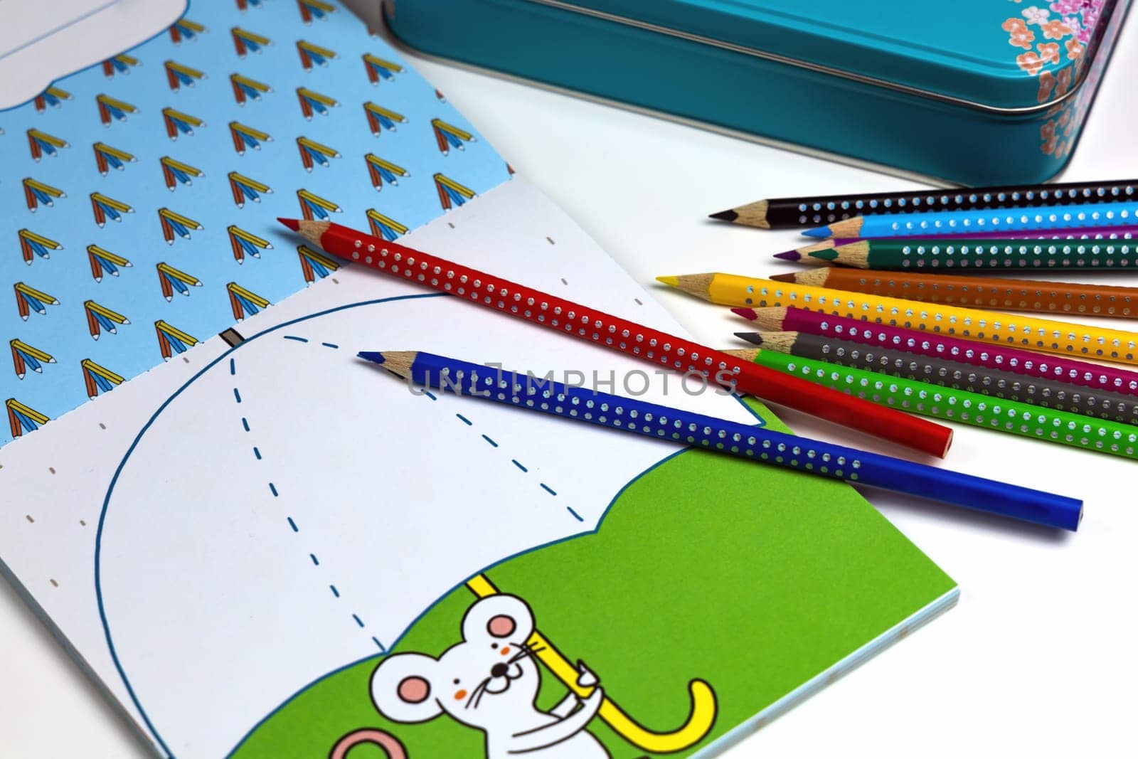 Colored pencils for drawing various colors and coloring book for children. Children's creativity concept.