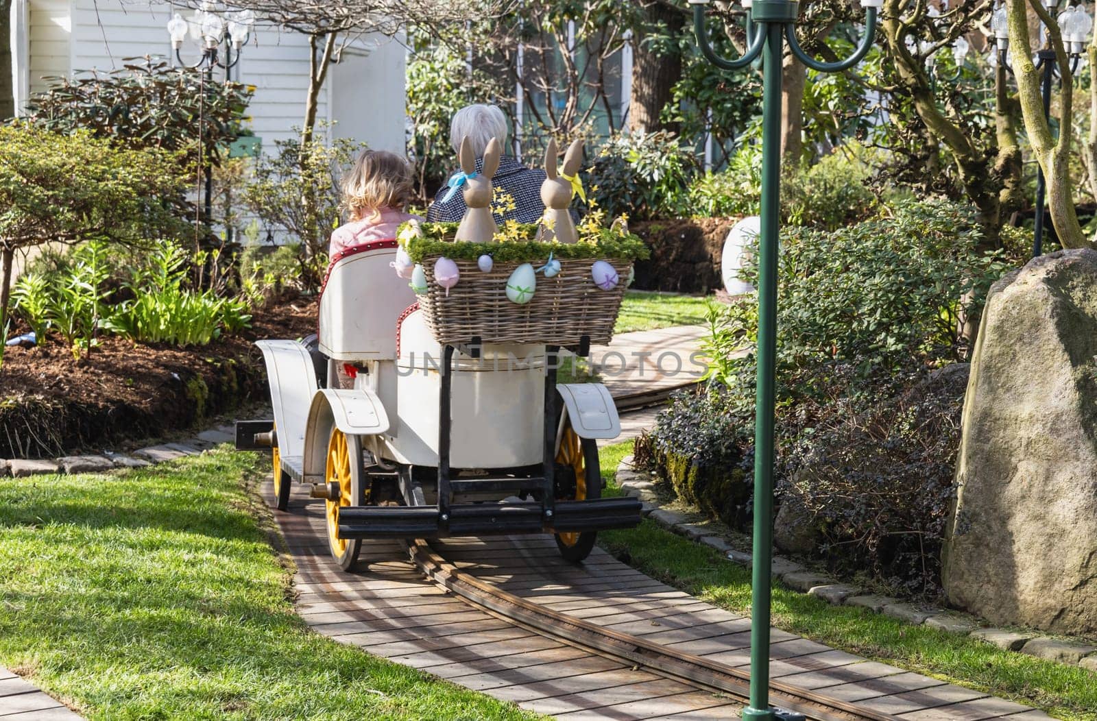 Attraction for children, car in an amusement park decorated with Easter eggs and bunnies. Entertainment for Easter.