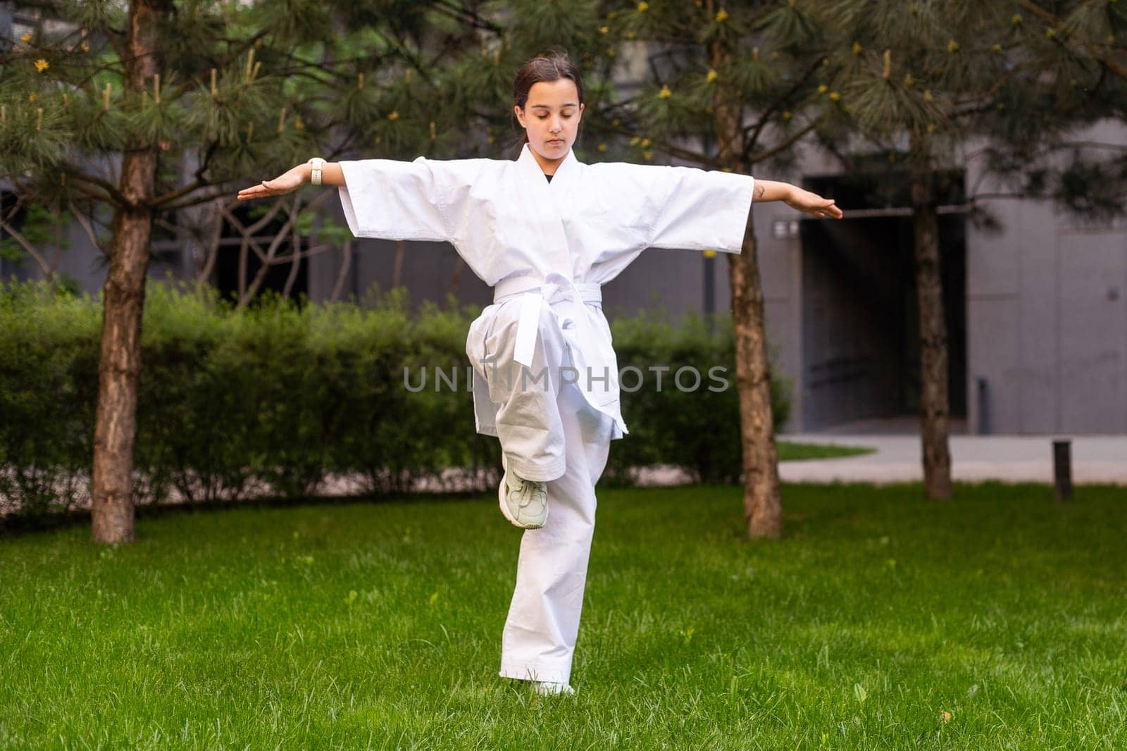 young girl in a white kimono, karate. High quality photo