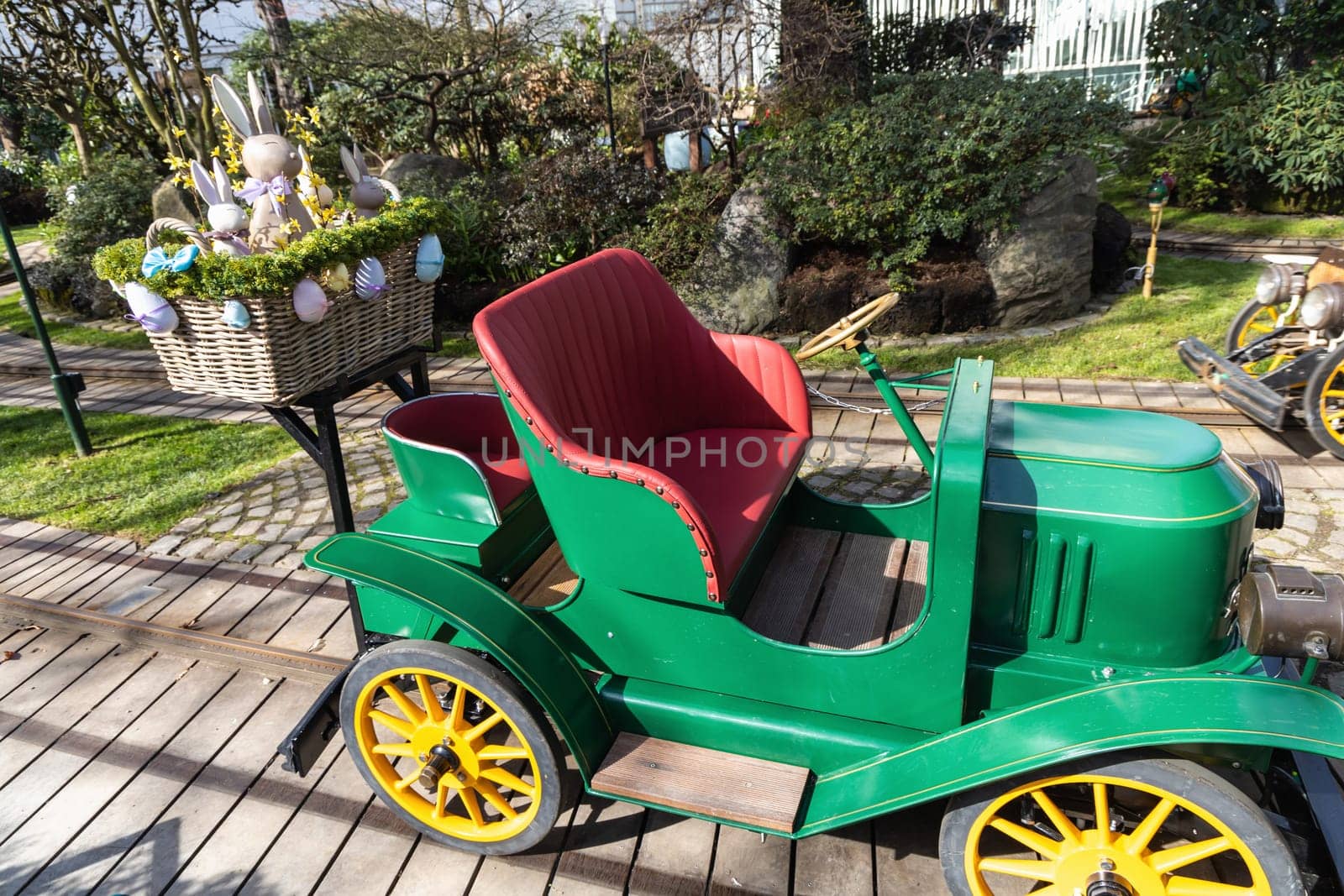 Attraction for children, car in an amusement park decorated with Easter eggs and bunnies. Entertainment for Easter.