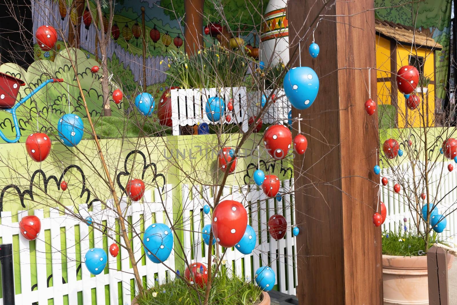 Decorative Easter eggs hanging on tree branches. Easter concept.
