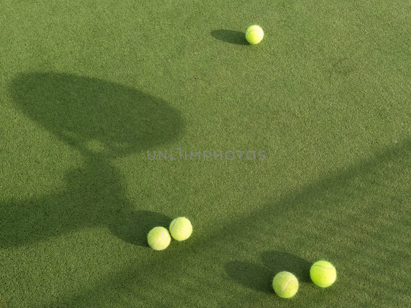 Paddle tennis racket shadow and ball on turf. Outdoors image with racket shadow. High quality photo