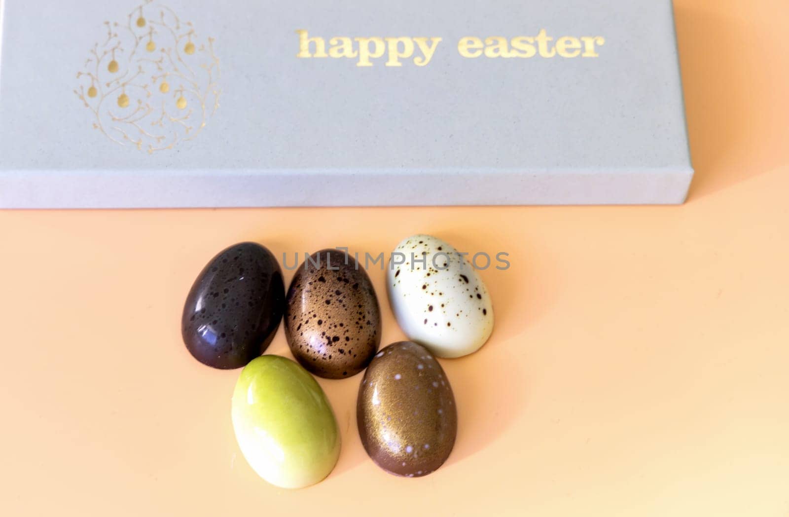 A box of chocolate eggs with the inscription in English Happy Easter. Easter concept.