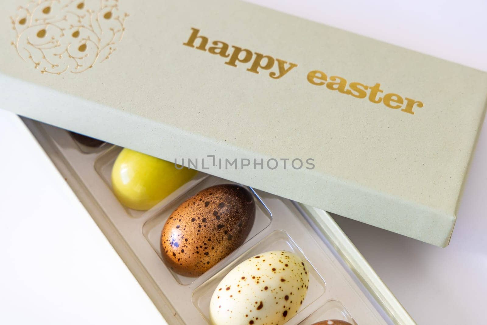 A box of chocolate eggs with the inscription in English Happy Easter. Easter concept.