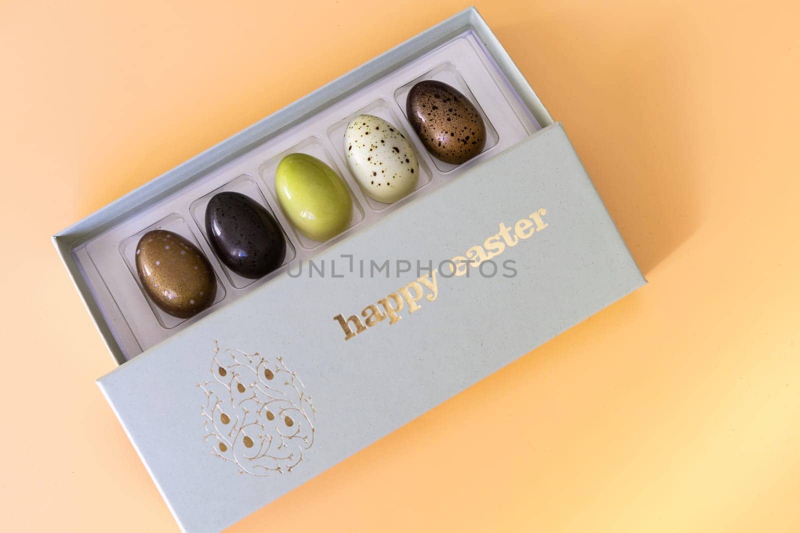 A box of chocolate eggs with the inscription in English Happy Easter. Easter concept.
