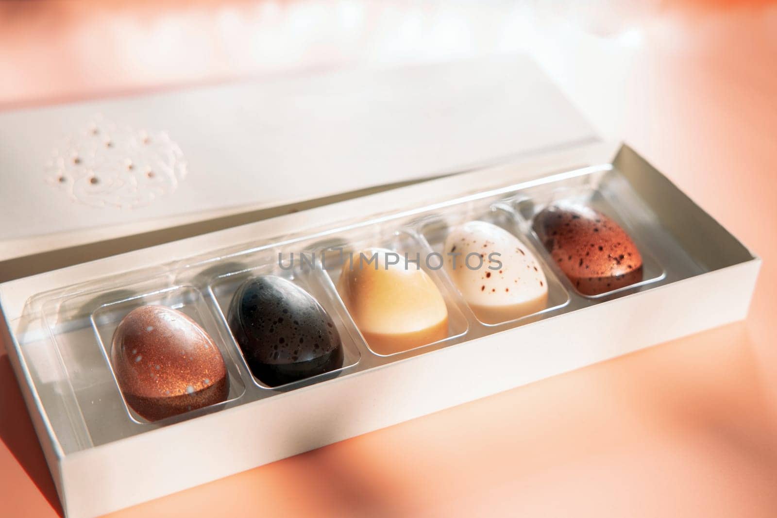 A box of chocolate eggs with the inscription in English Happy Easter. Easter concept.