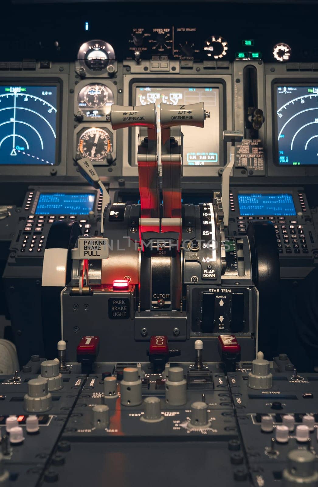 Cockpit view of an airplane during a night-time flight with illuminated instrument panels