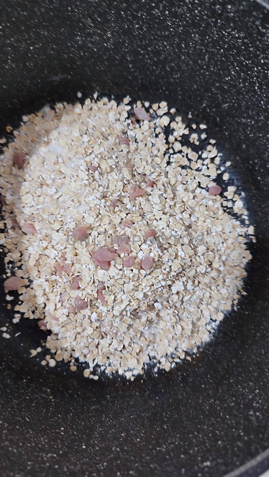 white cereal in a black pan, food by Ply