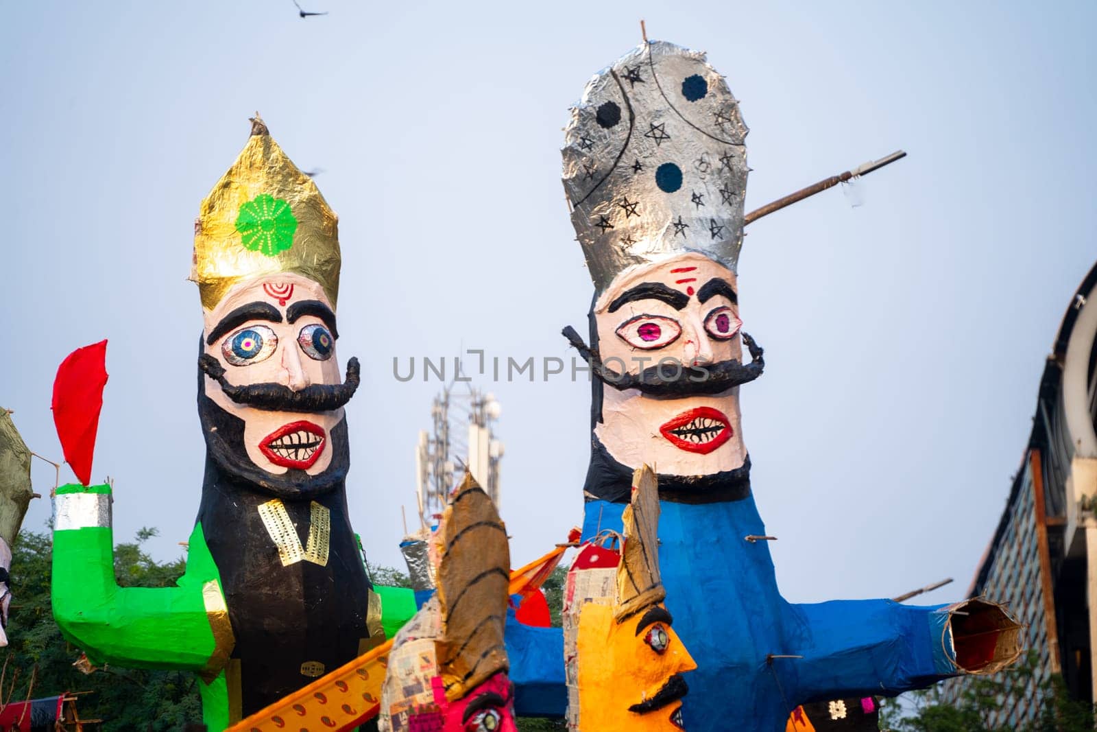 Colorful effigies of demon king Ravan of paper made on the hindu festival of Dussehra Vijayadashami shot with shallow depth of field by Shalinimathur