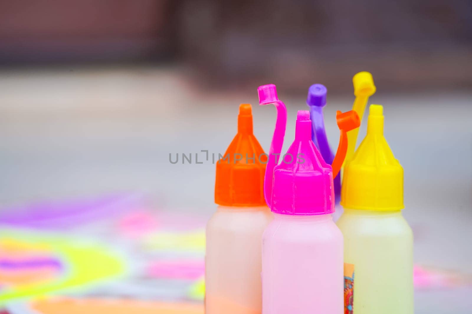bottle of color powder used to make a rangoli a traditional art made on floors during festivals of diwali, dussera, onam in hindu culture by Shalinimathur