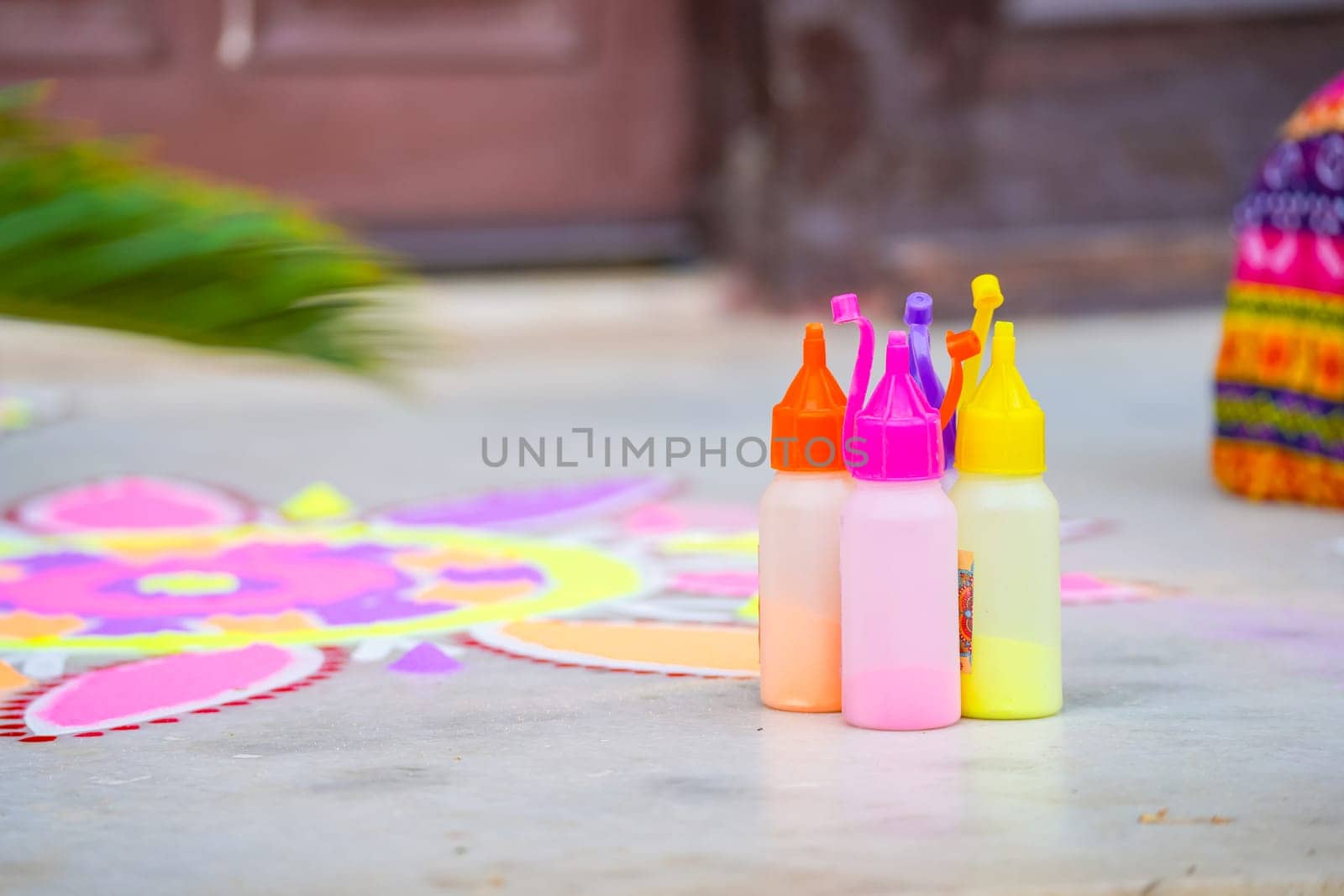bottle of color powder used to make a rangoli a traditional art made on floors during festivals of diwali, dussera, onam in hindu culture