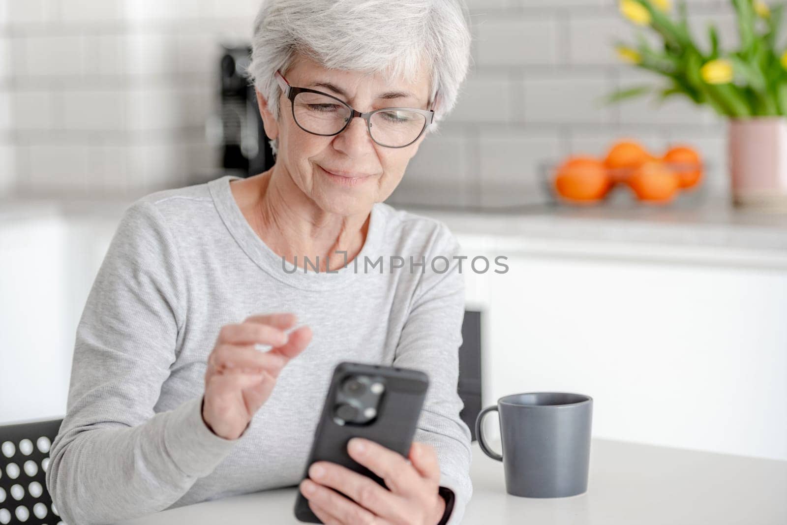 Grey-Haired Attractive Woman Searches For Information On Phone by tan4ikk1