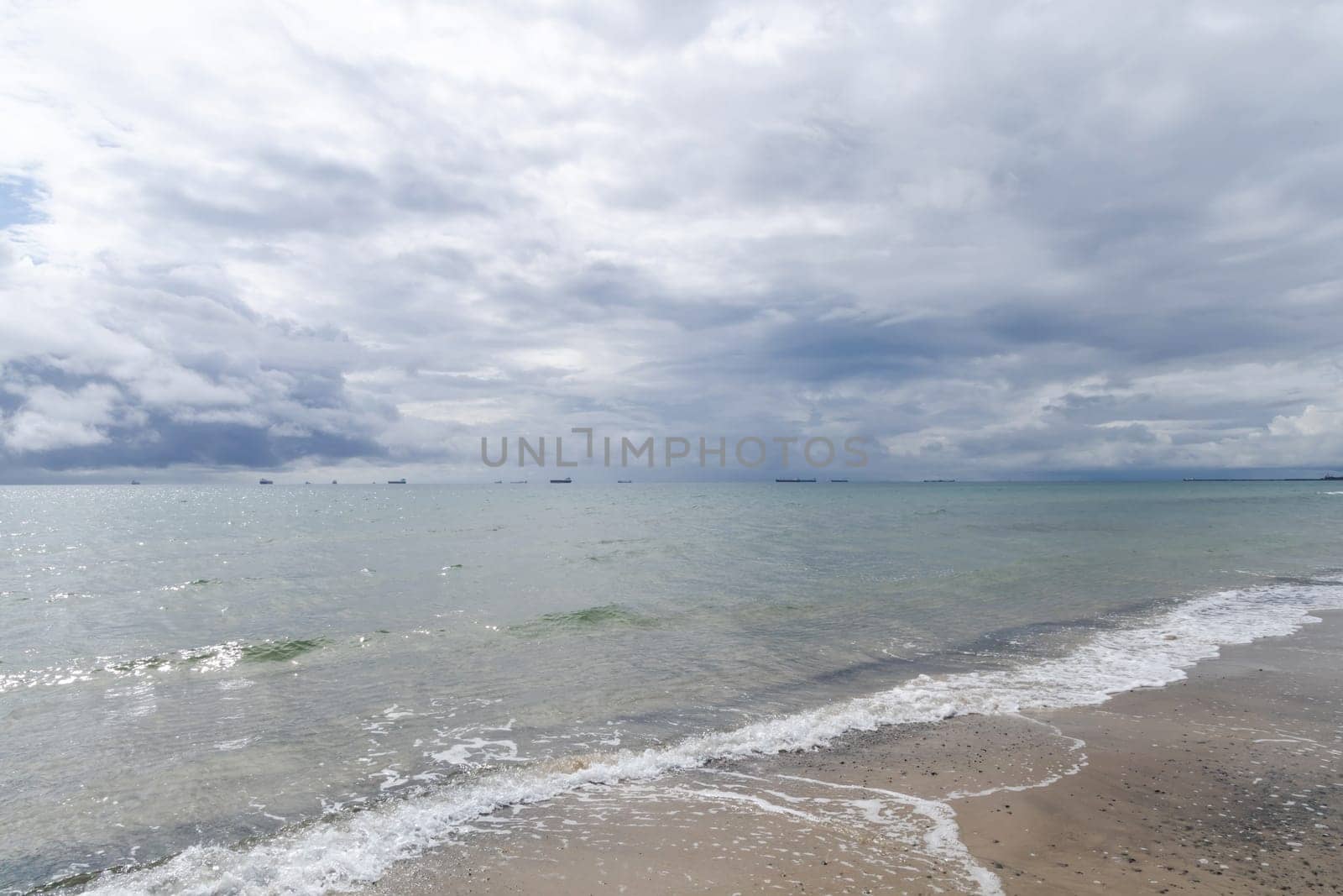 Dramatic seascape in dark colors. Dark sky with clouds over the stormy sea. High quality photo