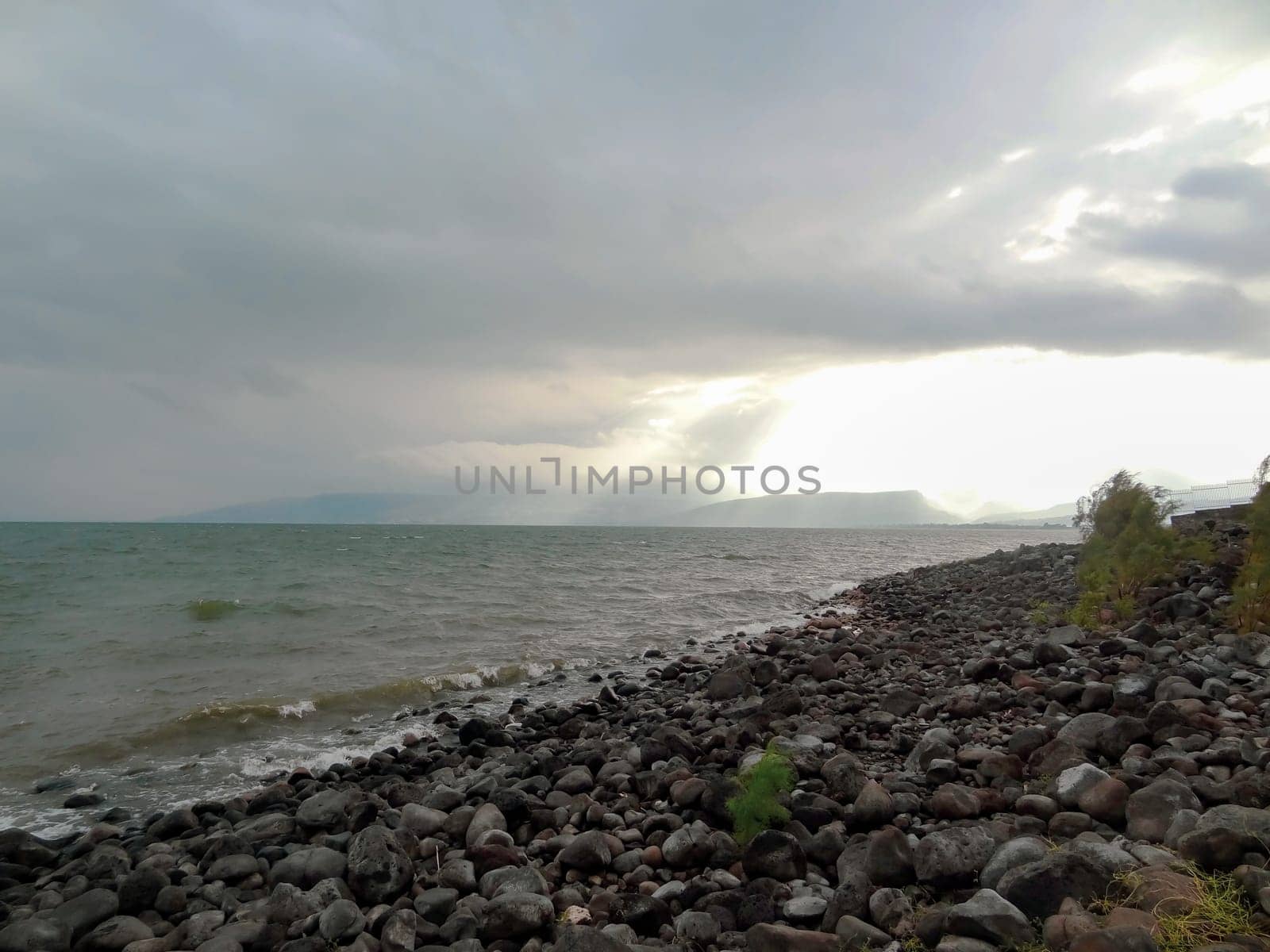 Rocky shore of the sea or lake.The sea of Galilee also called Lake Tiberias or Kinneret, Israel. High quality photo