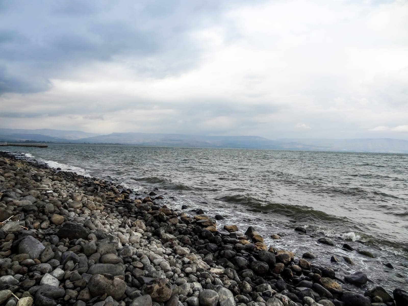 Rocky shore of the sea or lake.The sea of Galilee also called Lake Tiberias or Kinneret, Israel. High quality photo